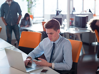 Image showing businessman working using a laptop in startup office