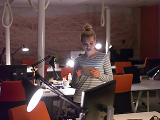 Image showing woman working on digital tablet in night office