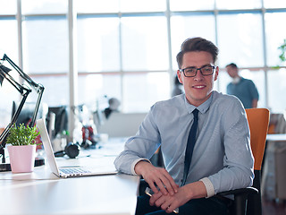 Image showing businessman working using a laptop in startup office