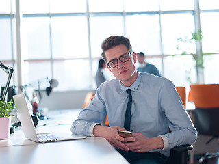 Image showing businessman working using a laptop in startup office