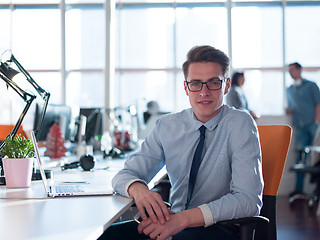 Image showing businessman working using a laptop in startup office