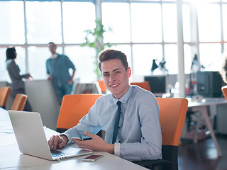 Image showing businessman working using a laptop in startup office