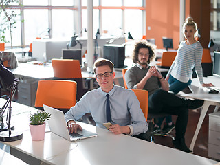 Image showing businessman working using a laptop in startup office