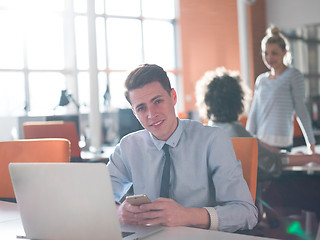 Image showing businessman working using a laptop in startup office