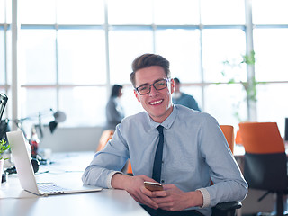 Image showing businessman working using a laptop in startup office