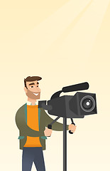 Image showing Cameraman with a movie camera on tripod.