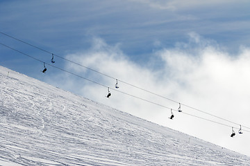 Image showing Snow off-piste ski slope and chair-lift in fog