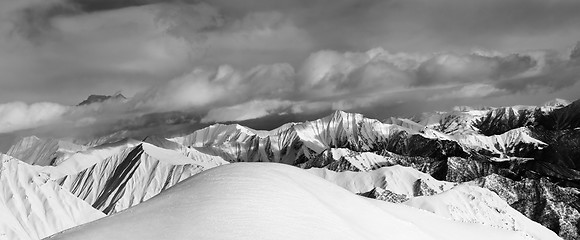 Image showing Black and white panoramic view on off-piste snow slope and cloud