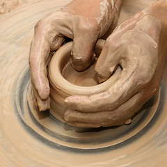 Image showing Hands in clay at process of making ceramic on pottery wheel