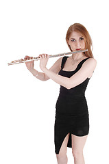 Image showing Woman standing, playing the flute