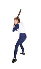 Image showing Woman swinging her bat in softball