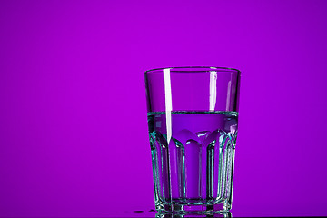 Image showing The water in glass on lilac background