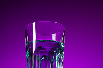 Image showing The water in glass on lilac background