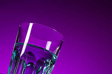 Image showing The water in glass on lilac background