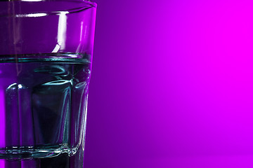 Image showing The water in glass on lilac background