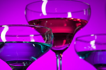 Image showing Three wine glasses standing on the table at studio