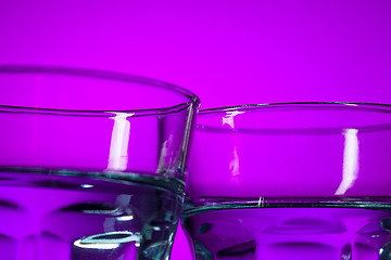 Image showing The water in two glassese on lilac background