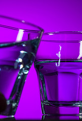Image showing The water in two glassese on lilac background
