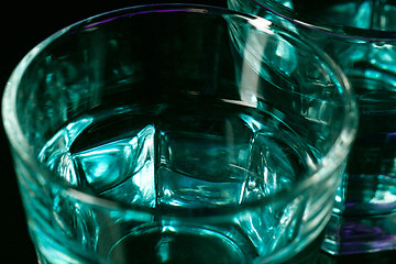 Image showing The water in two glassese on lilac background