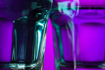 Image showing The water in two glassese on lilac background