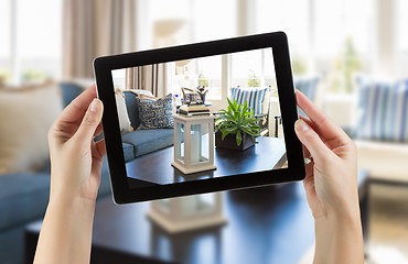 Image showing Female Hands Holding Computer Tablet In Room with Photo on Scree