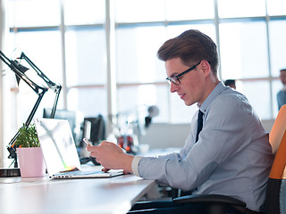 Image showing businessman working using a laptop in startup office