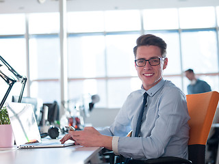 Image showing businessman working using a laptop in startup office