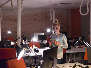 Image showing woman working on digital tablet in night office