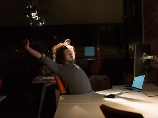 Image showing man working on computer in dark office