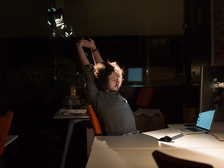 Image showing man working on computer in dark office