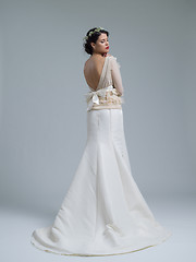 Image showing Rear view of a beautiful young woman in a wedding dress