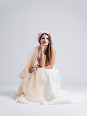 Image showing young bride sitting in a wedding dress