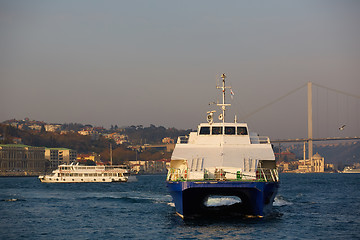 Image showing Tourist boat sails on the Golden Horn in Istanbul at sunset, Turkey.