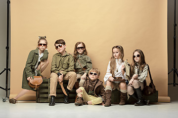 Image showing The group of beautiful girls and boys on a pastel background