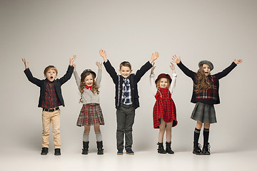 Image showing The group of beautiful girls and boys on a pastel background