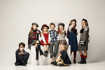 Image showing The group of beautiful girls and boys on a pastel background