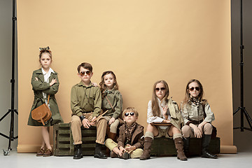 Image showing The group of beautiful girls and boys on a pastel background