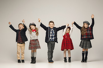 Image showing The group of beautiful girls and boys on a pastel background