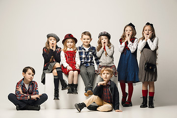 Image showing The group of beautiful girls and boys on a pastel background