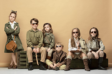 Image showing The group of beautiful girls and boys on a pastel background