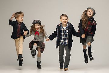 Image showing The group of beautiful girls and boys on a pastel background