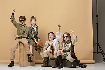 Image showing The group of beautiful girls and boys on a pastel background