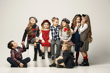 Image showing The group of beautiful girls and boys on a pastel background