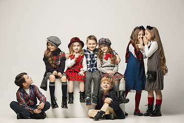 Image showing The group of beautiful girls and boys on a pastel background