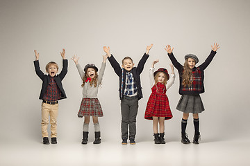 Image showing The group of beautiful girls and boys on a pastel background