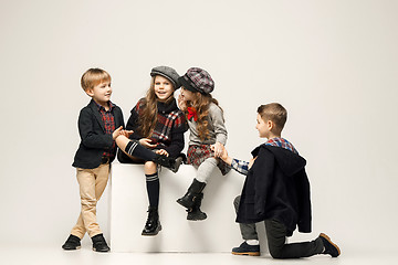 Image showing The group of beautiful girls and boys on a pastel background