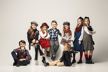 Image showing The group of beautiful girls and boys on a pastel background