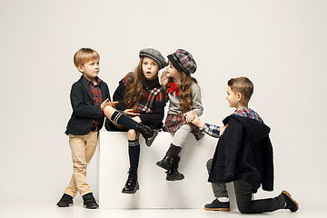 Image showing The group of beautiful girls and boys on a pastel background