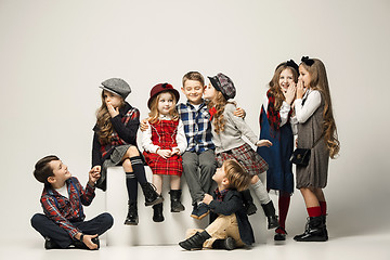 Image showing The group of beautiful girls and boys on a pastel background