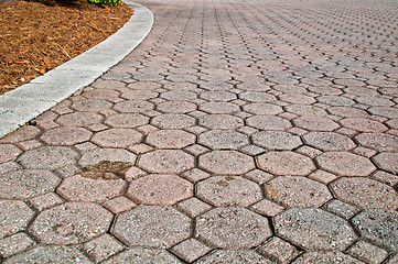 Image showing low angle stained brick paver driveway